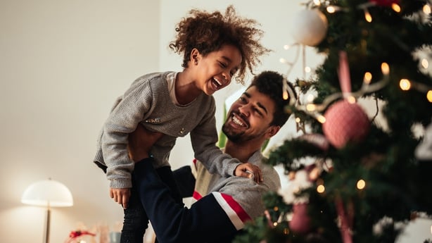  father and daughter celebrating Christmas with love at home.