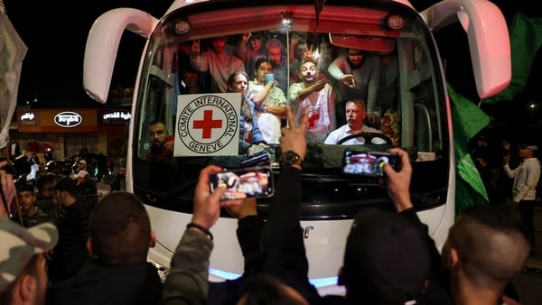 A bus transporting Red Cross staff and Palestinians released from Israeli jails drives through Ramallah in the West Bank this morning
