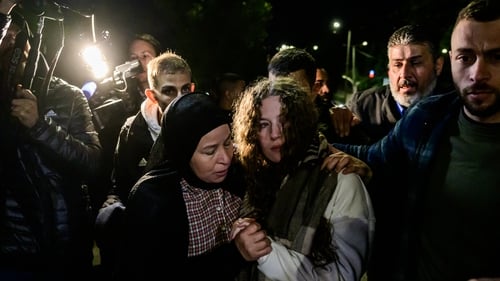 Newly released activist Ahed Tamimi (R) is greeted by her mother following the release of Palestinian prisoners from Israeli jails